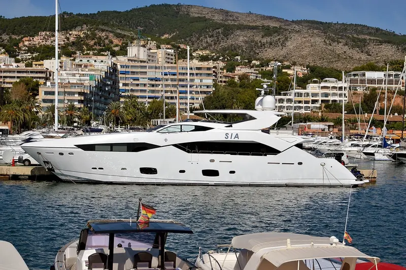 A large motor yacht at Portals with the hills of Calvia behind.