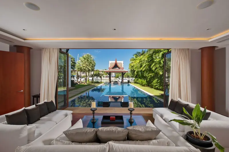 The view out from inside a Royal Villa: private pool, a Thai sala pavilion and the marina basin beyond, the on-water living Royal Phuket Marina is built around.