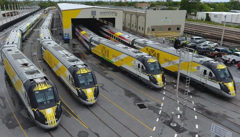 Brightline trains at the West Palm Beach workshop. The line puts Miami and Orlando within a straightforward run of the yard, which matters when an owner is visiting a refit.