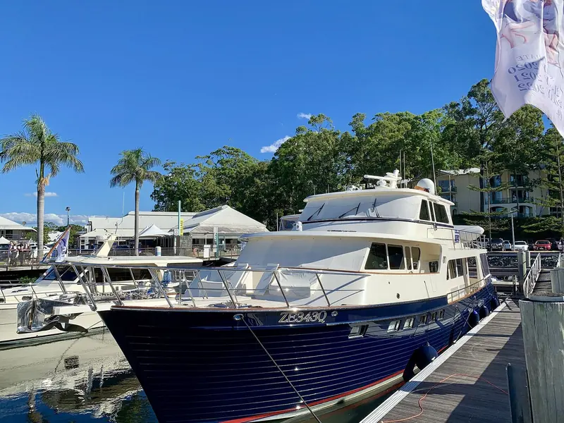 A cruising motor yacht alongside. Boats of this type, set up for long Australian coastal passages, are the marina's core trade.