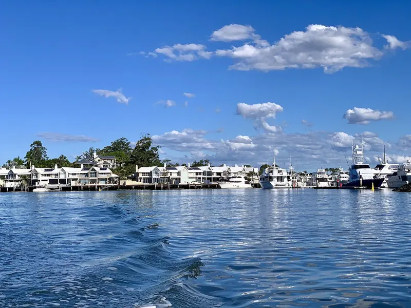 Houses along the Coomera River near Hope Island. This is the water a yacht comes up, and the depth in it is what governs how big a boat can reach the berth.