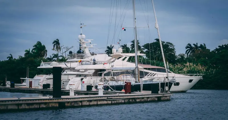 A yacht alongside the palm-lined quay at Shelter Bay Marina, on the former Fort Sherman waterfront at the Caribbean mouth of the Panama Canal.