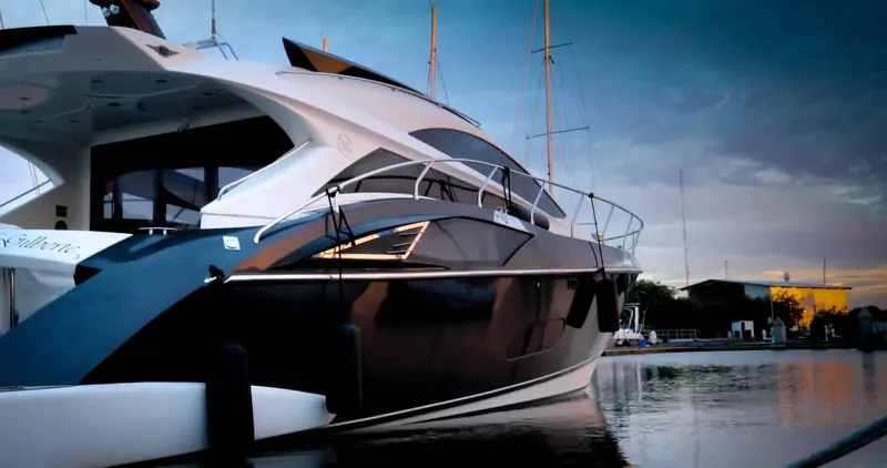 A motor yacht on the quay at dusk, one of over 6,000 ft of dock space the marina publishes.