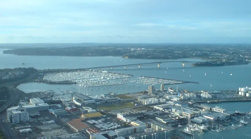 Looking down from the city, the waterfront runs west past the silos to the mass of Westhaven and out under the Harbour Bridge toward the Waitemata.