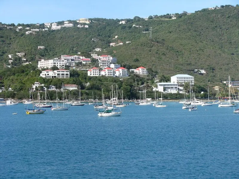 Hillside hotels and villas look down on the crowded mooring field in the western arm of the harbour, where smaller boats lie clear of the yacht docks.