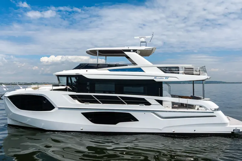 The Absolute Navetta 64 at anchor, showing the full-displacement hull and raised pilothouse profile.