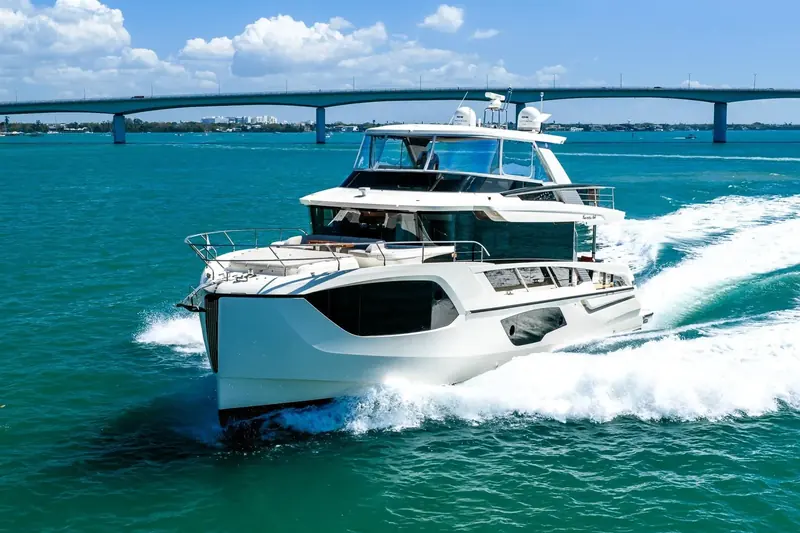 A Navetta 64 running past a Sarasota, Florida bridge, a 2022-built hull listed for sale.