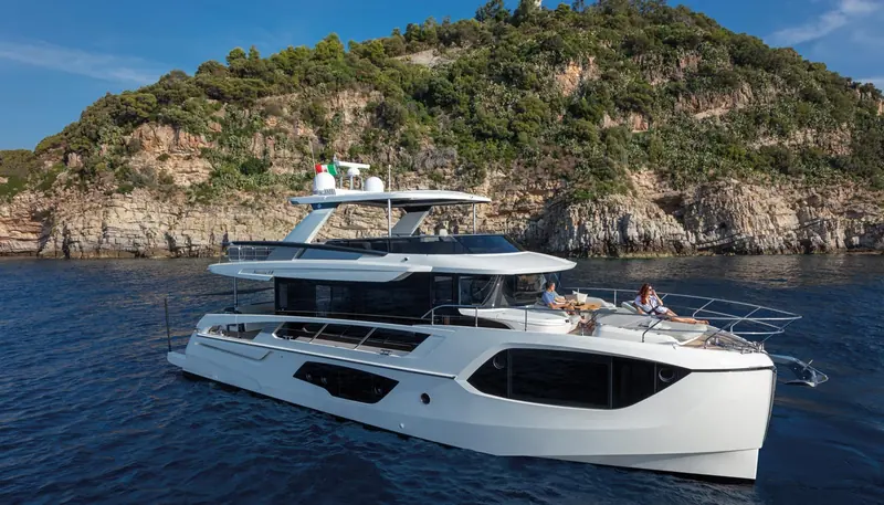 The Navetta 64 anchored alone off a rocky headland.