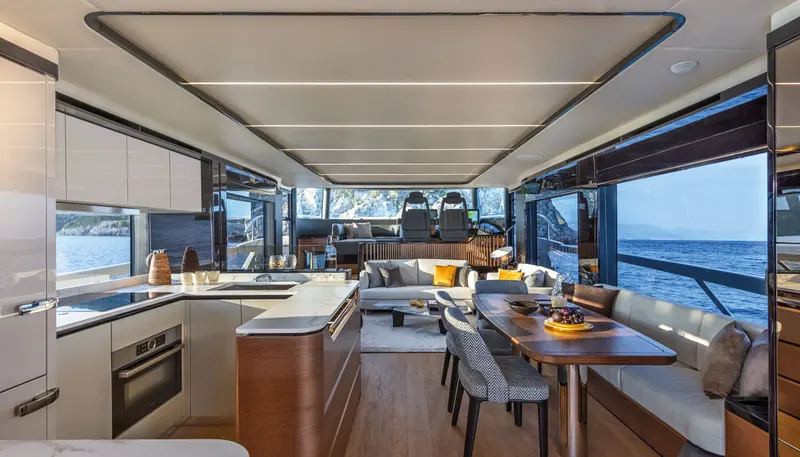 The Navetta 64's main-deck galley and saloon, finished in light oak.