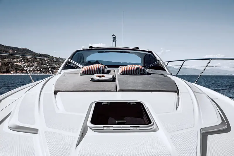 The foredeck sunpad, split in two and finished with a teak-effect non-slip surface and a forward hatch for the cabin below.