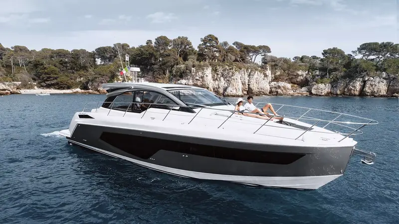 Directly overhead approaching the swim platform, showing how the transom sunpad, helm and forward lounge are laid out on one open deck.