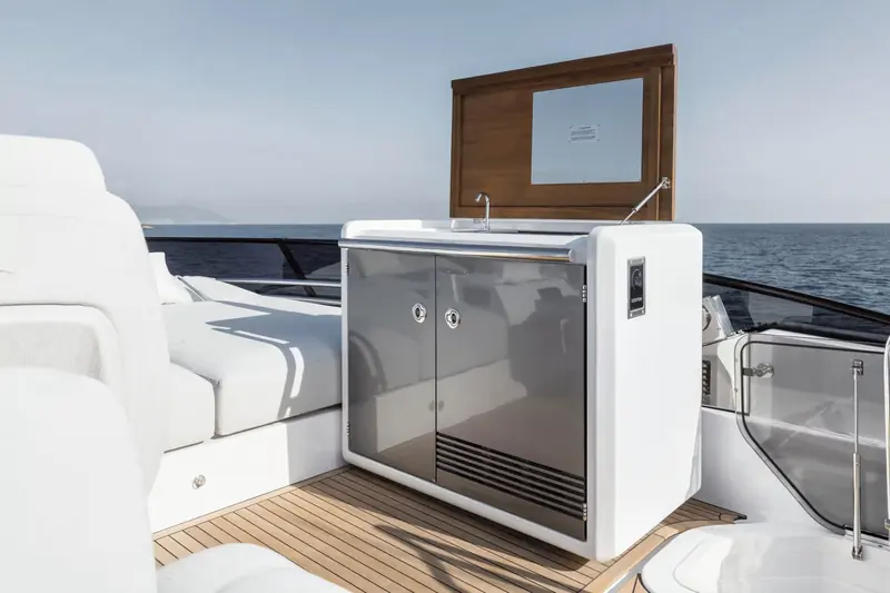 The flybridge wet bar opened up for service, set into the aft end of the upper deck social area.