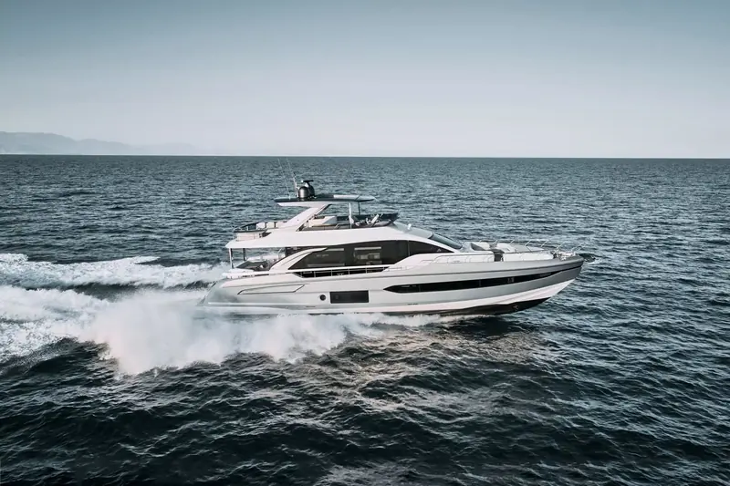 The Fly 78 at speed off the Montenegrin coast, throwing a wide, broken wake typical of the planing hull rather than the trailing furrow of a displacement design.