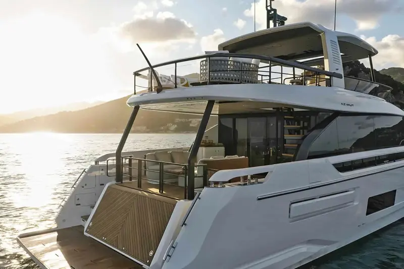 Aft cockpit at anchor off the Italian Riviera, the sofa and dining area open to the transom with the swim platform lowered.