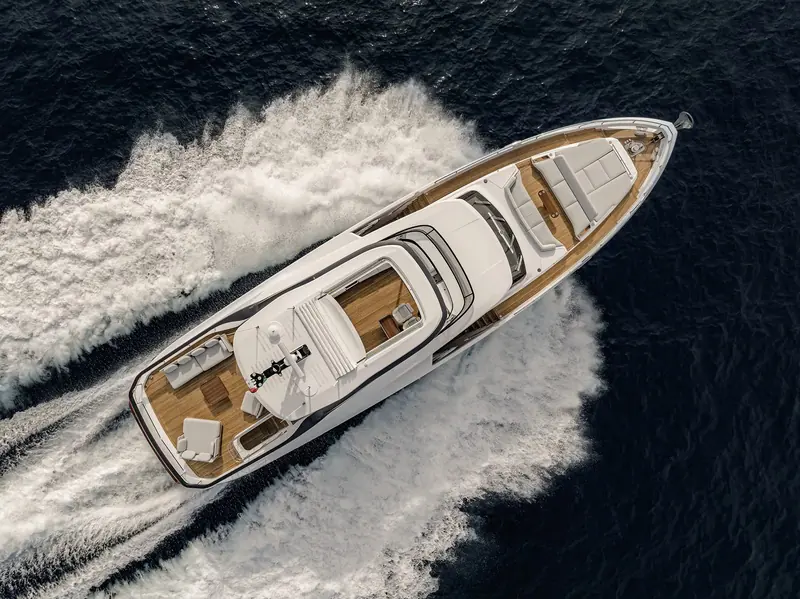 Seen from directly overhead at speed, the layout reads clearly: foredeck lounge forward, enclosed flybridge amidships, open cockpit aft, all inside a hull that looks far smaller from above than its 26 metres.
