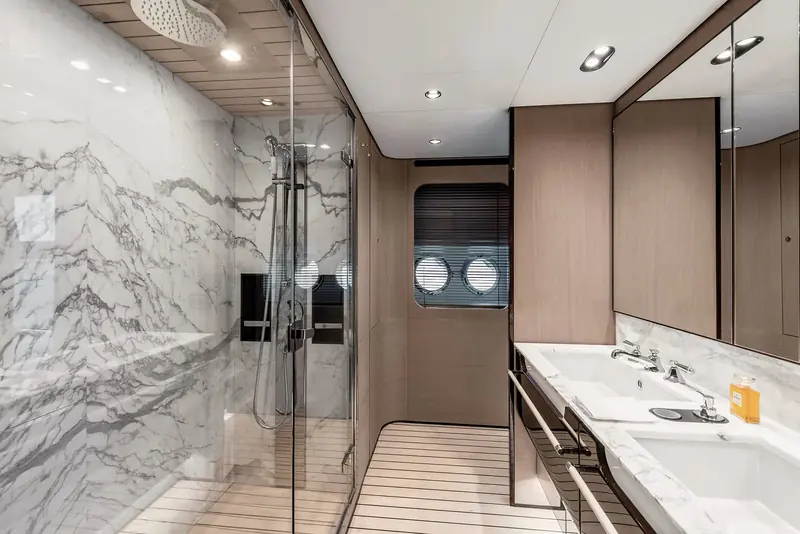 One of the bathrooms, book-matched grey marble running from the shower wall to the vanity top.