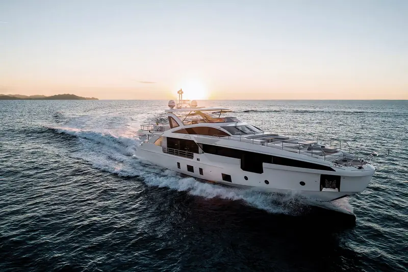 The Grande 32M on the plane at sunset, hull number cutting a hard-chined wake typical of Azimut's Grande series running gear.