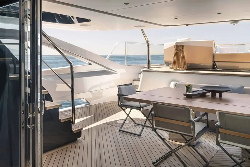 One of the two private side patios on the main deck, a fold-down balcony that turns a passageway into its own sunbathing platform when at anchor.