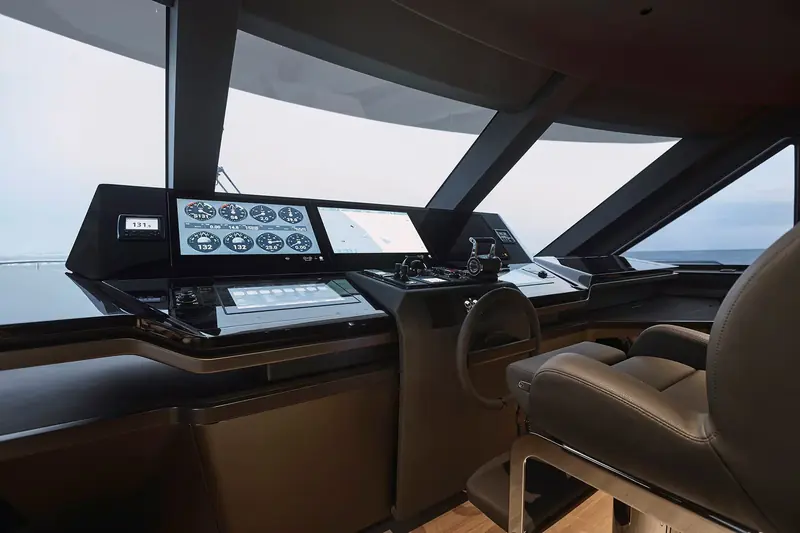 The wheelhouse underway, twin multifunction displays and analogue-style dials live with real trial data, the wraparound screen giving close to 180 degrees of sightline.