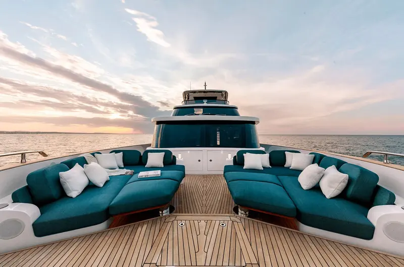 Forward cockpit seating wraps the bow, giving a second full lounge separate from the flybridge and main-deck aft deck - three distinct outdoor rooms on one hull.