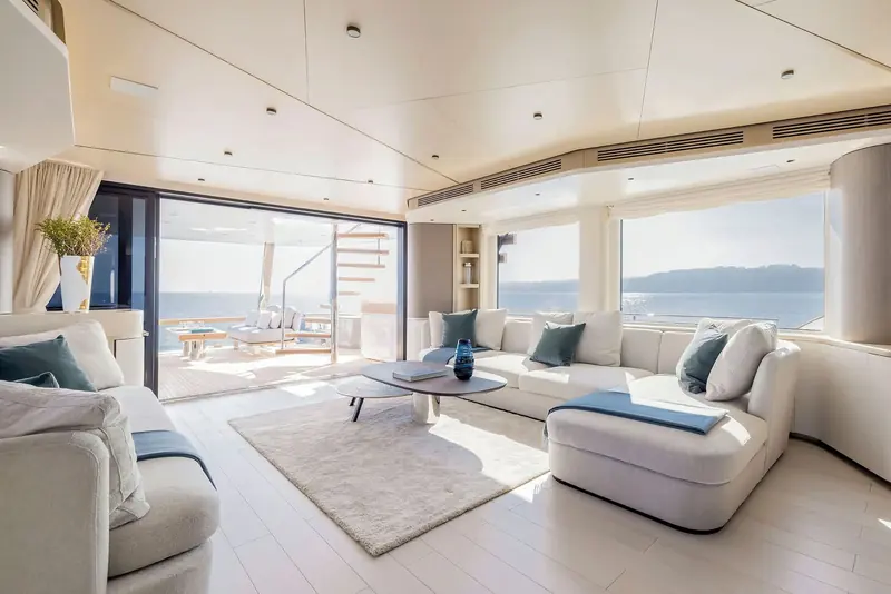 A second saloon view showing the sliding door straight onto the cockpit - the indoor and outdoor social spaces run together with almost no threshold.