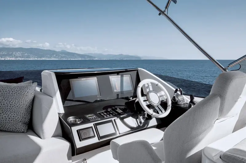 The lower helm from the co-pilot's seat, twin chart-plotter screens either side of the wheel and stitched leather bolsters either side of the console.