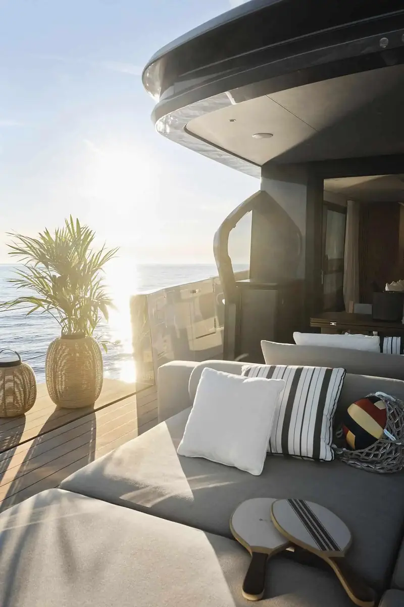 The Fun Island transformable cockpit set as a lounge, with paddle bats and a buoy left out, palm and rattan lantern staged for the golden hour.