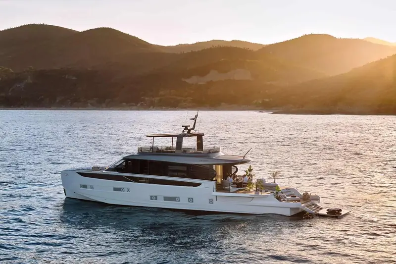 Lying at anchor at golden hour. The Seadeck 9 is the 26-metre flagship of the range, built to run on Volvo Penta's IPS hybrid system in and out of harbour.