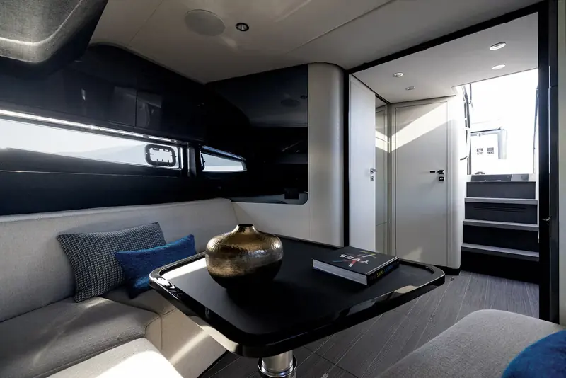 The cabin looking toward the companionway door and steps up to the cockpit, showing the finish of the below-deck accommodation and the single head compartment beyond.