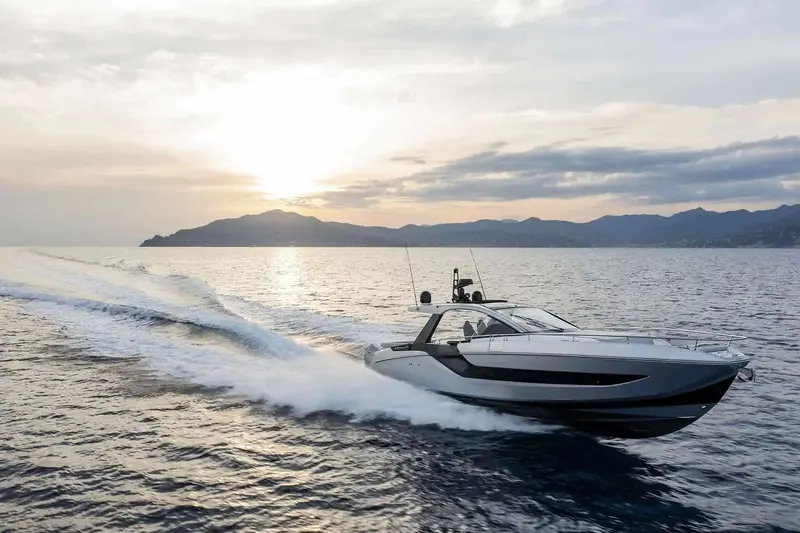Verve 48 running into a Ligurian sunset, the roll-bar hardtop and open transom that mark it out as Azimut's sports dayboat rather than a cruiser.