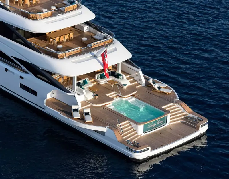 The swim platform and aft-deck jacuzzi on Lady Estey, teak decking, C-shaped seating and the hull name set into the transom.