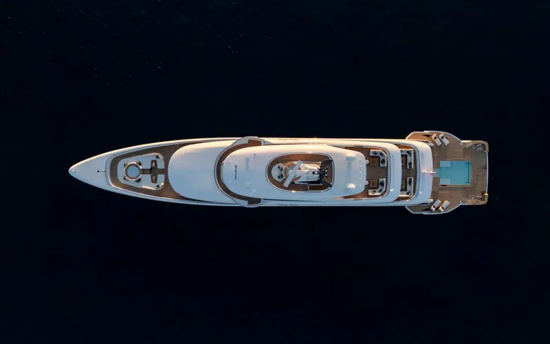 Overhead view of the B.Now 67M at anchor, showing the full deck layout from the foredeck lounge to the aft pool.