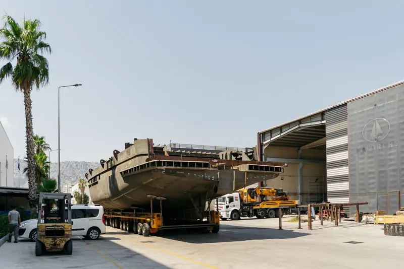 The Bering 110's steel hull under the shed roof at Bering's Antalya yard, moments before the turnover lift, 26 August 2026