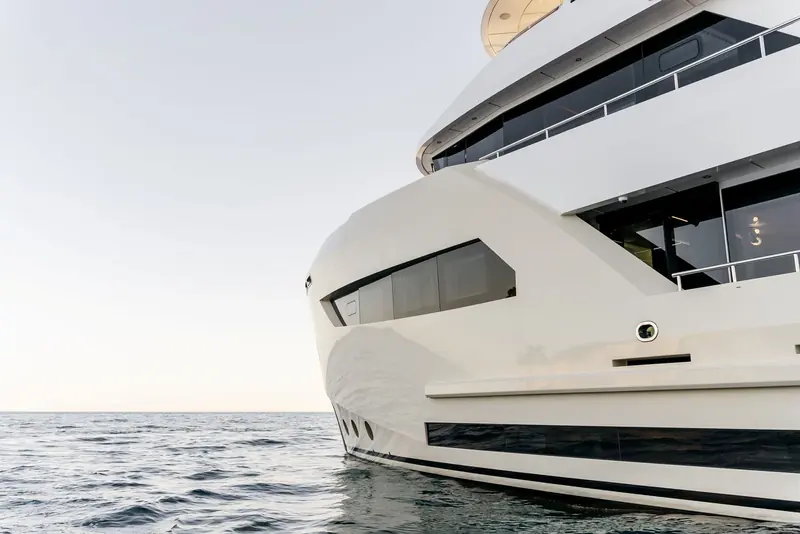 A bow-on view shows the flared, seakeeping hull shape that sits under the boxy explorer profile.