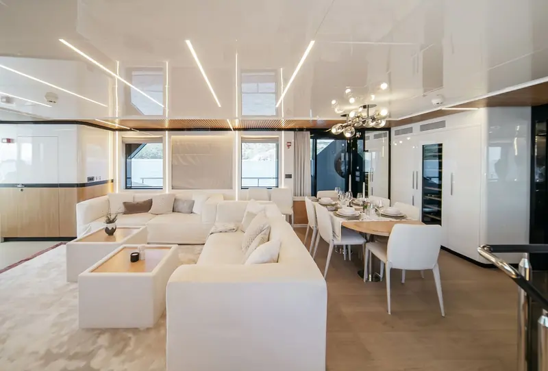 The main saloon and dining table seat guests together rather than splitting cooking, dining and lounging into separate rooms.