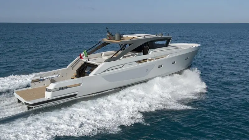 The Bluegame BG72 running off the Italian coast, flying the national flag from its foredeck lounge.