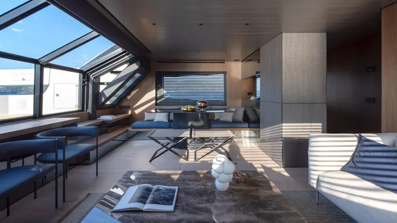 The BG72's main saloon and dining area, with the fold-out balcony window open to the sea.