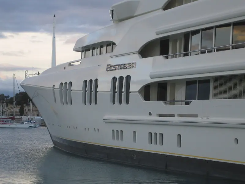A three-quarter bow view showing the raked stem and the stepped superstructure running aft - three full decks of accommodation stacked above the waterline.