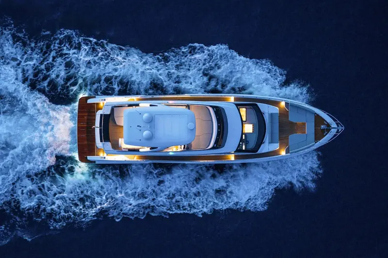 Running at night, seen from directly overhead: the full deck plan reads clearly, from the bow sunpad to the covered aft cockpit.