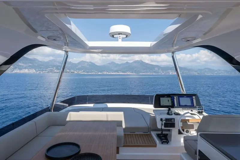 The flybridge helm station, twin displays either side of the wheel and a clear view forward over the bow.