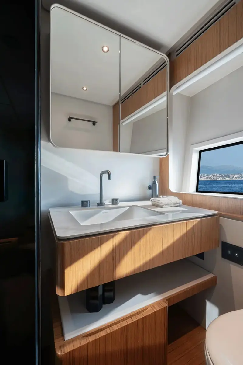 The ensuite basin and vanity in wood veneer, one of the guest cabins below deck.