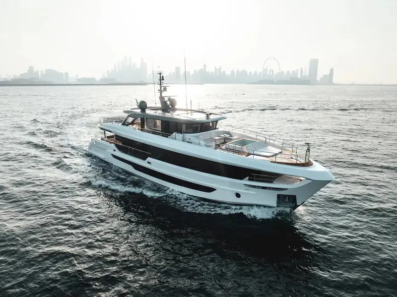 The Majesty 100 Terrace running past the Dubai skyline, the Ain Dubai wheel visible on the horizon and a foredeck jacuzzi built into the raised bow terrace that gives the model its name.