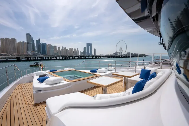 A flybridge jacuzzi and lounge sit against the Dubai Marina skyline with the Ain Dubai wheel visible behind, the model's main open-air entertaining deck.
