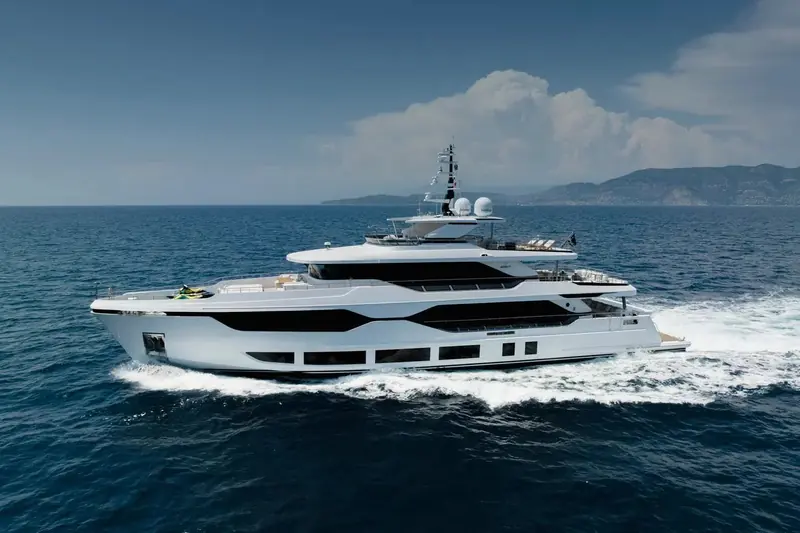 Running to starboard off the French Riviera coast. The three-deck profile and the black-glazed hull windows running the length of the accommodation deck are Majesty 120 recognition points at a distance.
