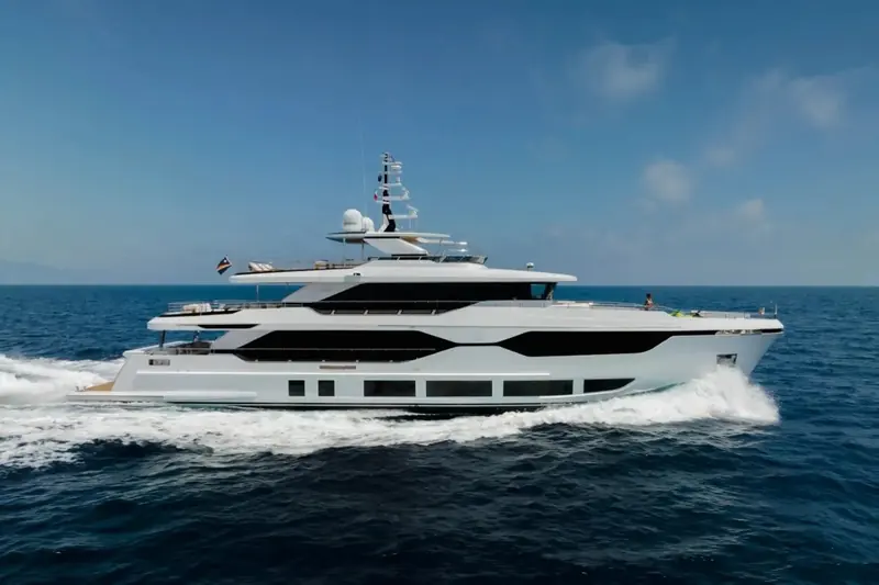 Underway at speed with a crew member on the foredeck. The chined bow and the flared topsides are shared with the smaller Majesty models, scaled up to 37.5 metres.