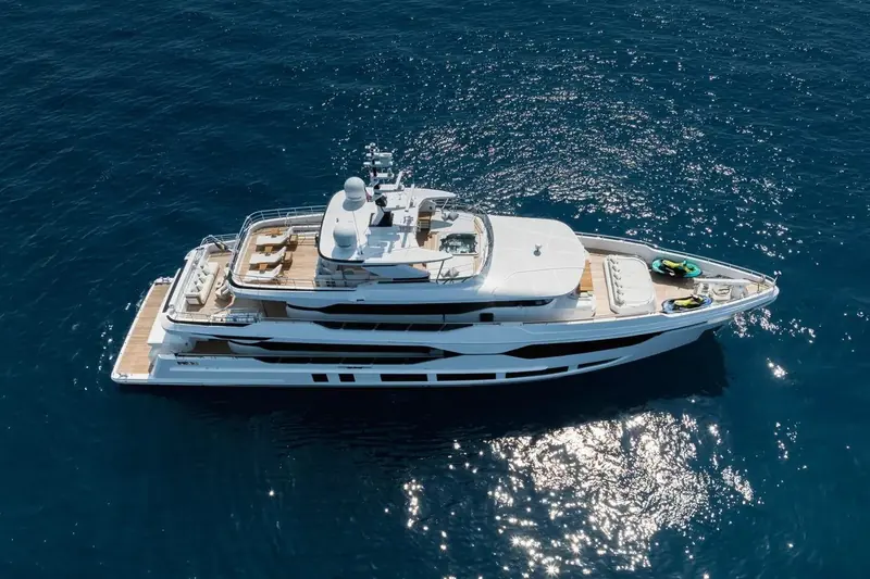 At anchor from directly overhead. The full-beam sundeck aft of the flybridge carries a jacuzzi, sunloungers and two jet skis stowed to starboard - deck space Gulf Craft points to as unusually generous for the length.