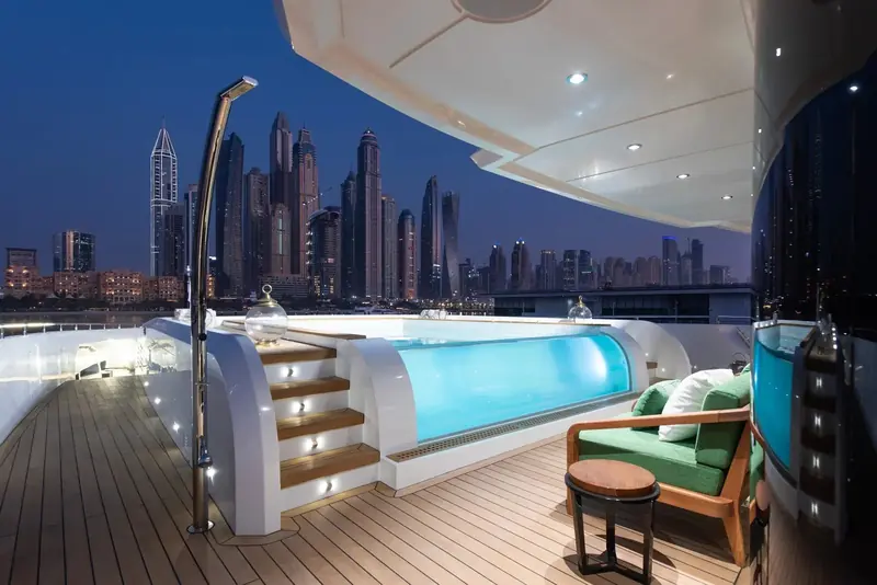 The aft beach-club deck opens onto a plunge pool and a night view of the Dubai Marina towers, the kind of entertaining space that used to need a boat well over 200 feet.