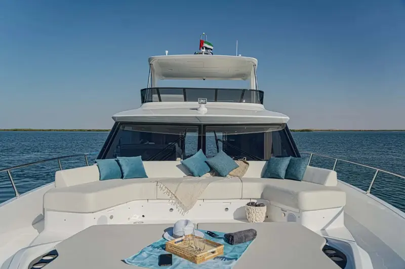 Foredeck sunpad shot from directly above, cushions and bolsters arranged for guests before getting under way.