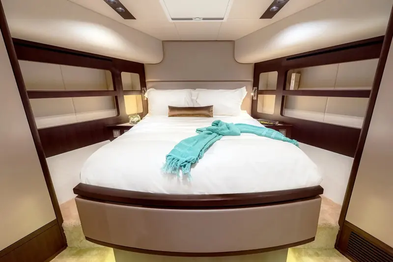 The owner's cabin is set forward with a centreline berth and dark wood trim against white surfaces, a finish level Gulf Craft positions between its production Oryx line and the full-custom Majesty flagships.