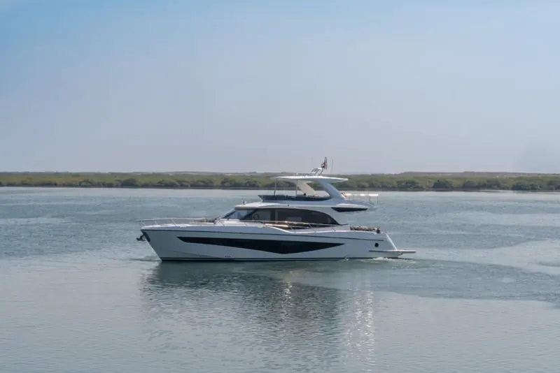 Close on the transom, the Majesty nameplate and swim platform visible beneath the overhanging flybridge deck.